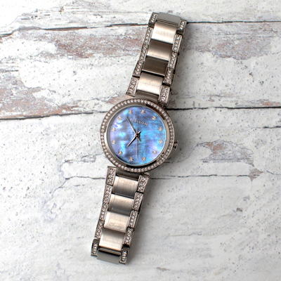 CITIZEN<sup>&reg;</sup>- Ladies Crystal Eco-Drive Watch. 
Silver-tone with Blue Mother of Pearl dial and crystal markers. The Stainless Steel bracelet and bezel are also accented with crystals for added brilliance. Eco-Drive allows it to charge by any light source indoors or out and will never need a battery. Water resistant to 50M. 
